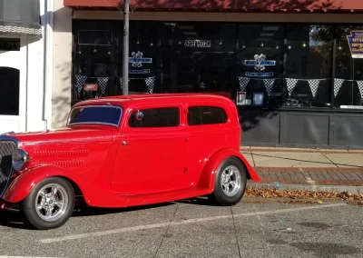 Red classic car in front of miller mountain high performance shop 1